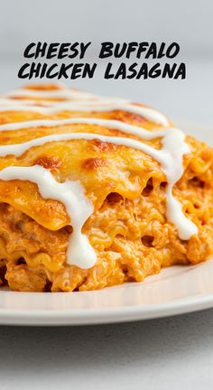 cheesy buffalo chicken lasagna on a plate with ranch dressing drizzled over top