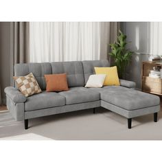 a gray sectional sofa with pillows on it