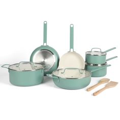 an assortment of pots and pans with wooden utensils