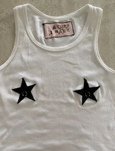 a white tank top with black stars on it