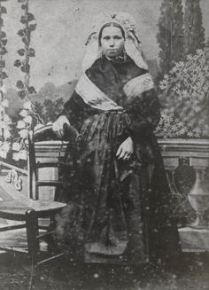 black and white photograph of a man sitting on a bench