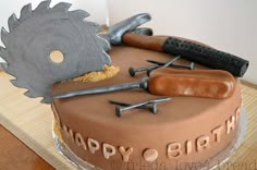 a birthday cake with a knife and some tools on it