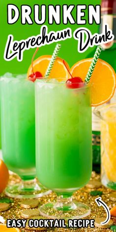 two glasses filled with green liquid and garnished with orange slices on the rim