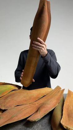 a man holding up a large piece of wood