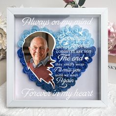 a heart shaped photo frame with an older man's face