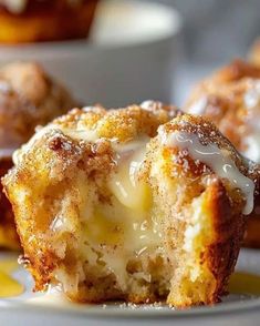 a close up of a muffin on a plate with some other muffins in the background