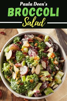 broccoli salad with almonds and cranberries in a white bowl on a wooden table