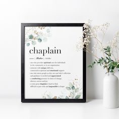 there is a vase with flowers next to a framed poster that says chaplain