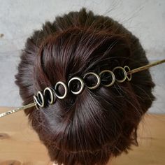 This loops hair slides are made with thick gauge solid copper wire or solid brass wire and oxidized to emphasize all the details. The barrette was carefully shaped and wrapped to give a great all day hold for most hair types. It can be bent to suit your style and volume of hair. Bending both the clip and the pin will give you maximum fit. Barrette sizes: Xsmall - 4,5 cm/ 1.7 in, stick 8 cm/ 3.1 in Small - 6 cm/ 2.4 in, stick 10 cm/ 4 in Medium - 8 cm/ 3.1 in, stick 12 cm/ 4.7 in Large - 10 cm/ 4 Hair Circle And Stick, Cheap Casual Adjustable Hair Accessories, Wire Wrapped Hair Pins, Brass Hair Pin, Hair Accessories Ribbon, Metal Hair Accessories, Diy Hair Accessories Ribbon, Bun Holder, Hair Clasp