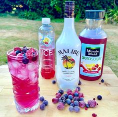 three different types of drinks sitting on top of a wooden table next to each other