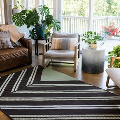 a living room filled with furniture and plants