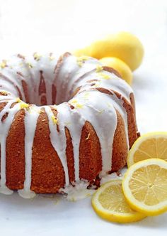 a lemon bunt cake with icing and sliced lemons