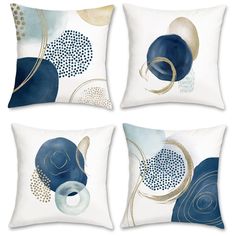 four decorative pillows with blue and gold designs on them, each featuring an abstract design