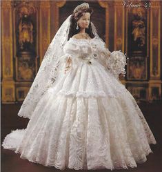 the doll is wearing a wedding dress and veil