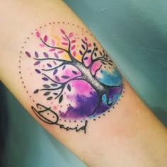 a colorful tree tattoo on the arm