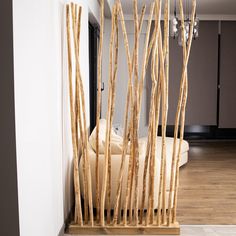 a living room filled with furniture and tall wooden sticks