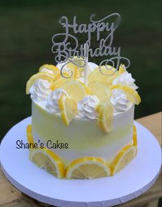 a birthday cake with lemon slices and white frosting