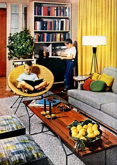 a man sitting in a living room reading a book next to a little boy on a couch