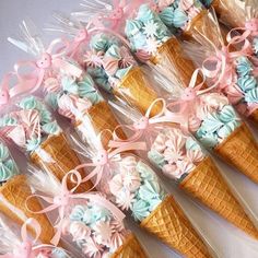 ice cream cones are decorated with pastel colors and ribbons for an elegant dessert display