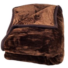 a brown and black blanket sitting on top of a white floor