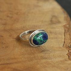 This is the perfect East-West Oval Ring and this Azurite Malachite is so gorgeous, revealing the classic blue of Lapis Lazuli and green of Malachite. The 10X14mm stone rests perfectly in this east west oval configuration. Simple and perfect with just an edge of .925 Sterling Silver. Wear this Azurite Malachite Statement Ring alone or on a hand full of rings. All traditional Silversmithing is done in my Baltimore MD studio. Azurite Malachite 10X14mm Ring top 14X18mm .925 Sterling Silver All tradi Hand Full Of Rings, Chloe Ring, Pink Opal Ring, Malachite Ring, Vintage Silver Jewelry, Malachite Rings, Purple Amethyst Ring, Purple Rings, Azurite Malachite