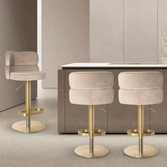 three white stools sitting in front of a counter