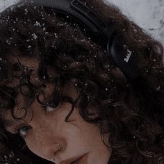 a woman with headphones on in the snow