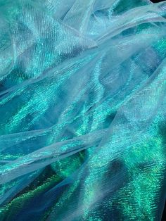 a close up view of a blue and green fabric