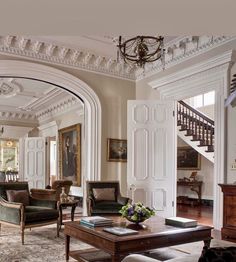 a living room filled with furniture and a staircase