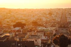 an aerial view of a city at sunset