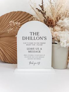 a memorial with flowers and an umbrella next to it on a white tablecloth background