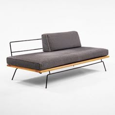 a black and white couch sitting on top of a wooden frame