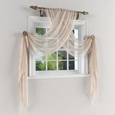 a window with sheer curtains hanging from it's side