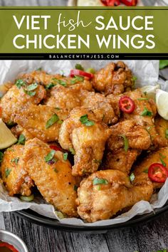 a plate full of fried chicken wings and garnished with cilantro sauce