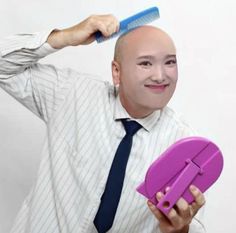 a man with a bald head holding a purple object