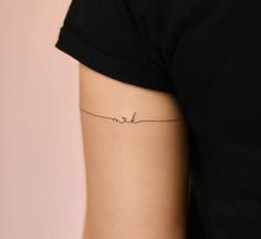 a woman's arm with a small tattoo on the left side of her body