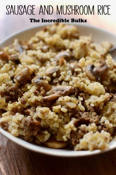 a bowl filled with rice and mushrooms on top of a wooden table