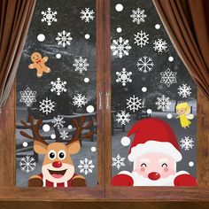 christmas window stickers with santa and reindeer looking out the window at snowflakes