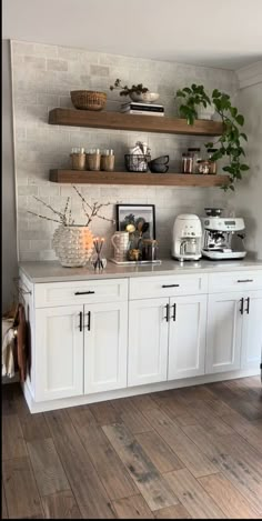 a kitchen with white cabinets and open shelves