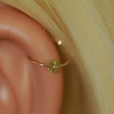 SINGLE HOOP :) SINGLE natural green peridot stone (approx. 3 mm) hoop earring. Each peridot stone is different :) for all piercings: nose, helix, tragus, ear. ★PLEASE choose★: - hoop with secure locking clasp - hoop with tiny claps -please see photo #2 or - infinity endless hoop - hoop without clasp - please see photo #3 Please choose Inner diameter- 7,8,9,10 mm Please choose material: ★100% 14K gold filled ★ ★100% Silver Sterling ★ Please choose gauge hoop: ★Gauge: the thickness of the wire the Gold Helix Earrings, Helix Earrings Hoop, Piercings Nose, Gold Hoop Earring, Earrings Cartilage, Cartilage Ring, Helix Hoop, Cartilage Earrings Hoop, Cartilage Hoop