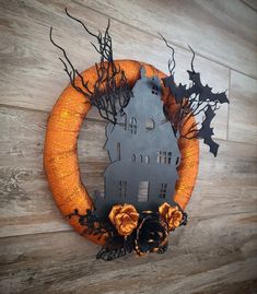 a halloween wreath with bats and pumpkins on it