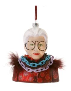 a glass ornament with a woman's head wearing glasses and a chain around her neck