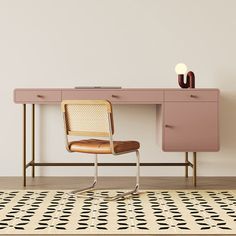 a pink desk with a chair next to it and a black and white rug on the floor