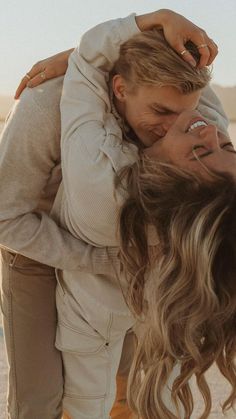 two women embracing each other in the desert