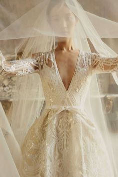 a woman wearing a wedding dress and veil