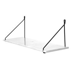 a white marble shelf with black metal brackets