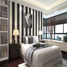 a bedroom with black and white striped walls