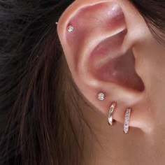 a close up of a person's ear with two different types of piercings