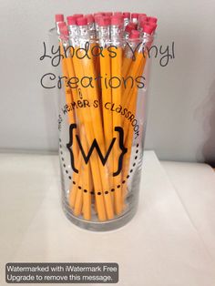 there are many pencils in a clear cup with writing on the bottom and inside