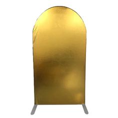 a gold colored display stand with metal legs and an arch shaped like a heart on the top